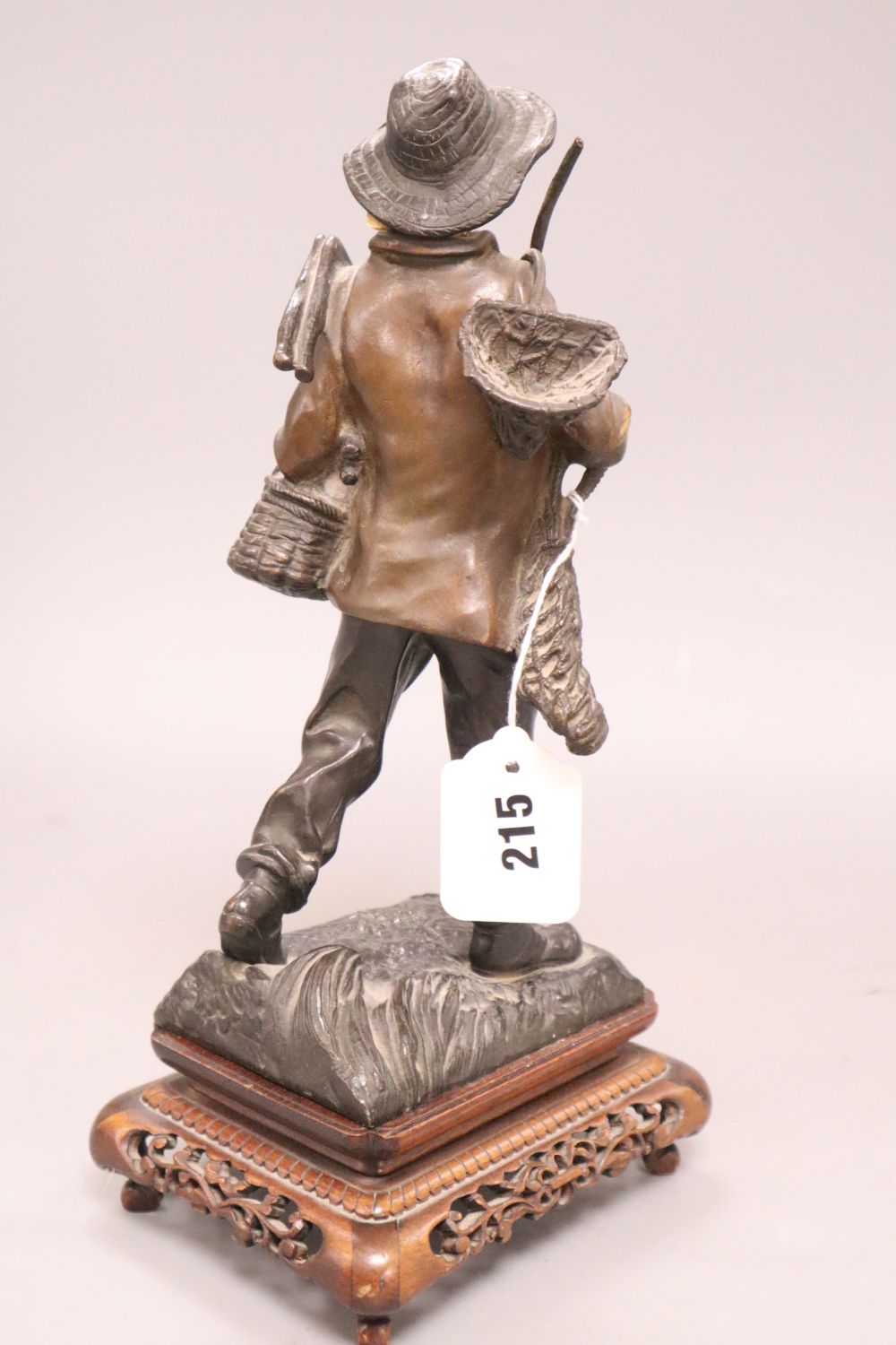 Rousseau. A bronze and ivory figure of a fisherboy, signed, height 26cm